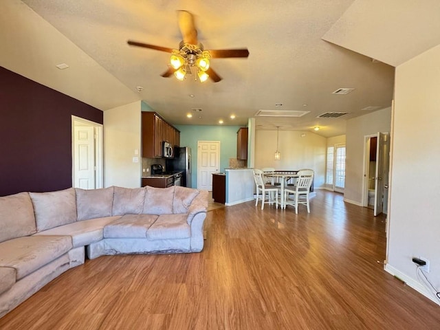 unfurnished living room featuring wood-type flooring and ceiling fan