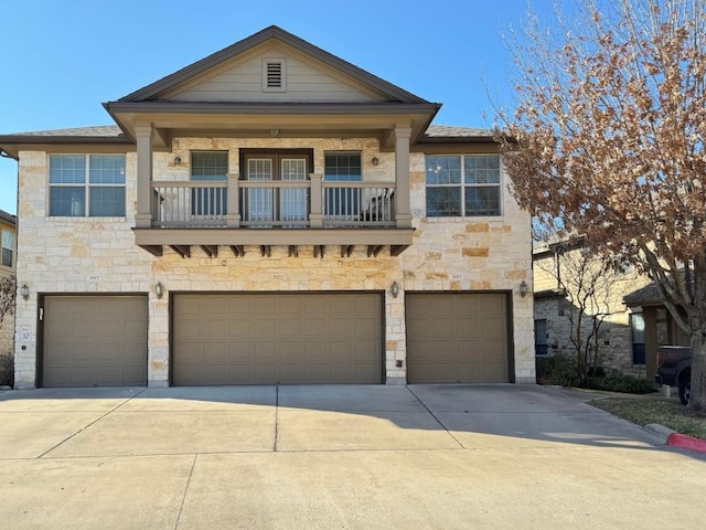 view of front of home featuring a balcony and a garage