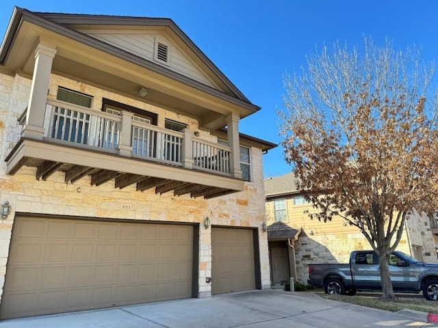 view of front facade featuring a garage and a balcony