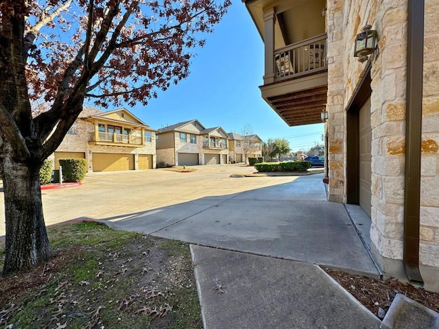 view of yard with a garage and a balcony