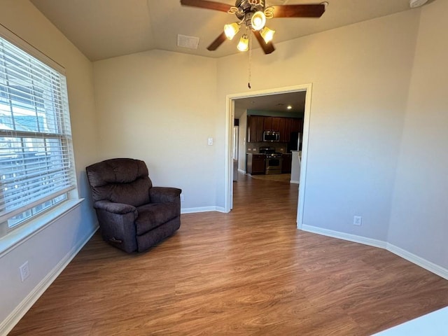 sitting room featuring lofted ceiling, hardwood / wood-style floors, and ceiling fan