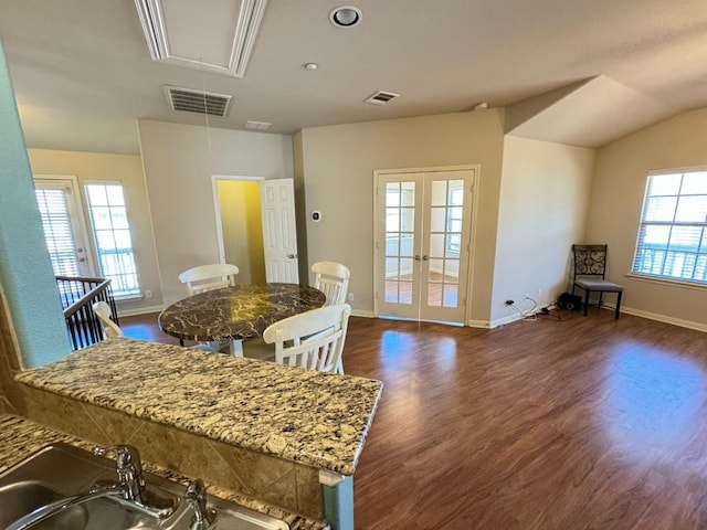 dining space featuring lofted ceiling, dark hardwood / wood-style floors, and french doors