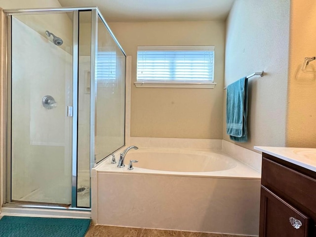 bathroom with vanity and independent shower and bath