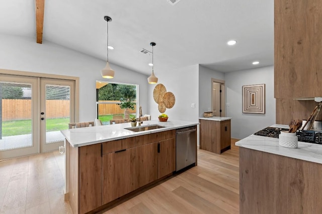 kitchen with an island with sink, sink, vaulted ceiling with beams, hanging light fixtures, and stainless steel dishwasher