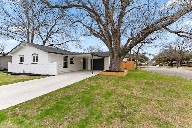 single story home with a garage and a front lawn