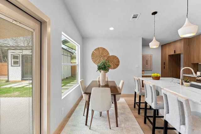 dining space with light hardwood / wood-style floors