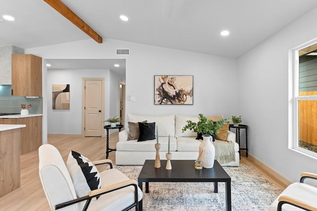 living room with vaulted ceiling with beams and light hardwood / wood-style floors