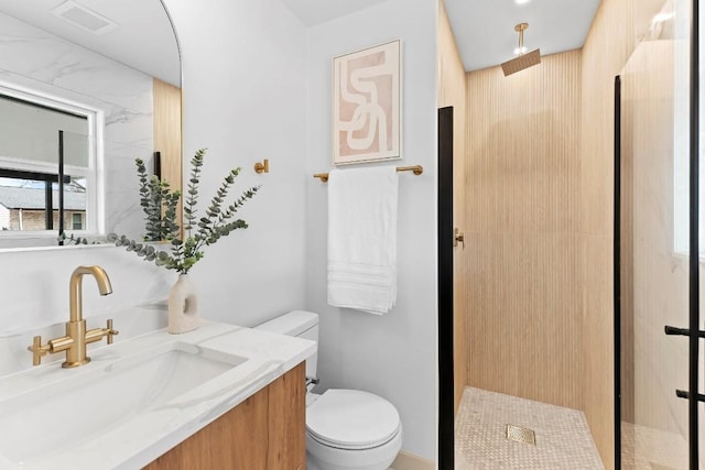 bathroom featuring walk in shower, vanity, and toilet