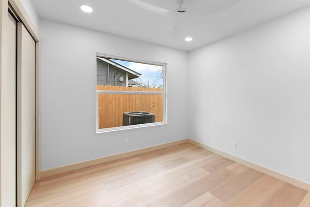 unfurnished bedroom featuring light hardwood / wood-style flooring, a closet, and ceiling fan