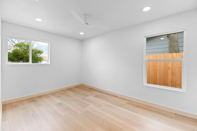 empty room featuring ceiling fan and light hardwood / wood-style flooring