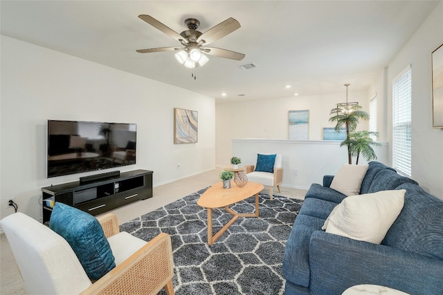 carpeted living room featuring ceiling fan