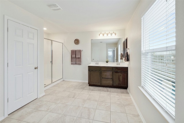 bathroom featuring a healthy amount of sunlight, an enclosed shower, and vanity