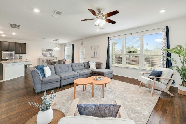 living area featuring recessed lighting, visible vents, dark wood-style flooring, and ceiling fan