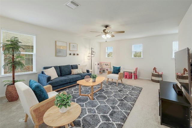 living room featuring ceiling fan and carpet