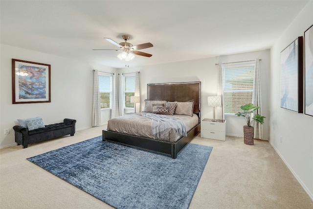 carpeted bedroom with baseboards and ceiling fan