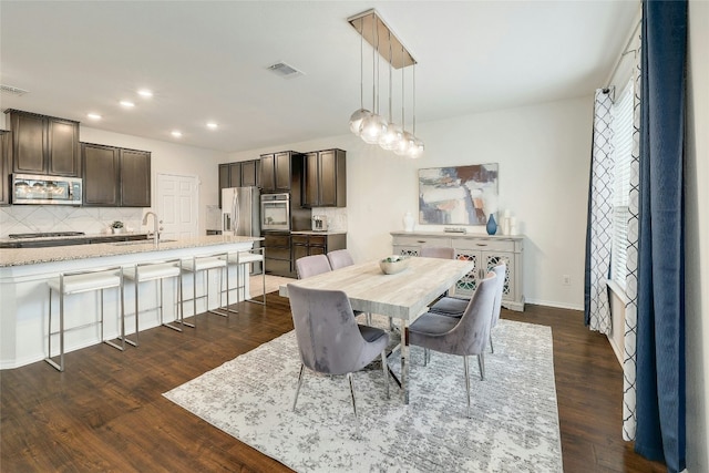 dining area featuring dark hardwood / wood-style floors and sink