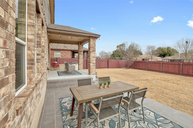 view of patio with an outdoor fire pit