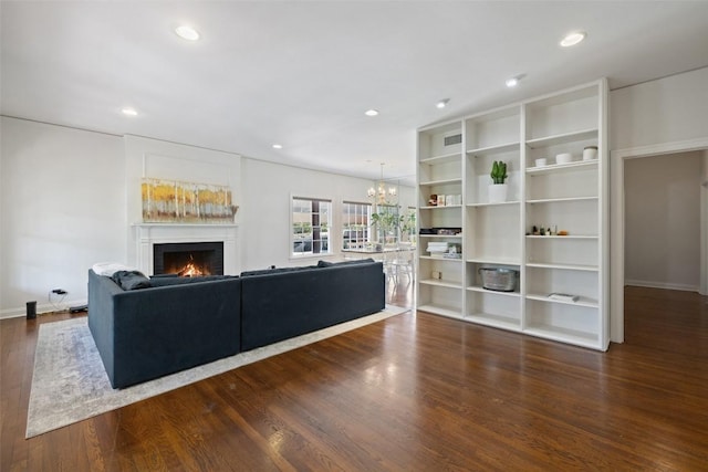 living room featuring dark wood-type flooring and a chandelier