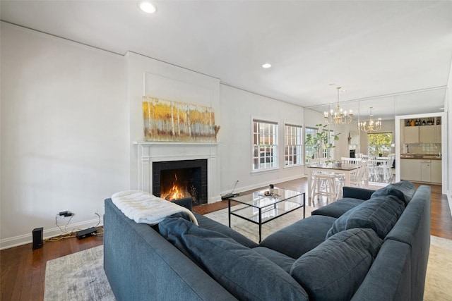 2612 Bridle Path, Austin, TX 78703 - living room featuring a chandelier, a lit fireplace, recessed lighting, baseboards, and wood finished floors