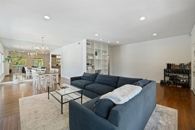 living room featuring dark wood-type flooring and an inviting chandelier