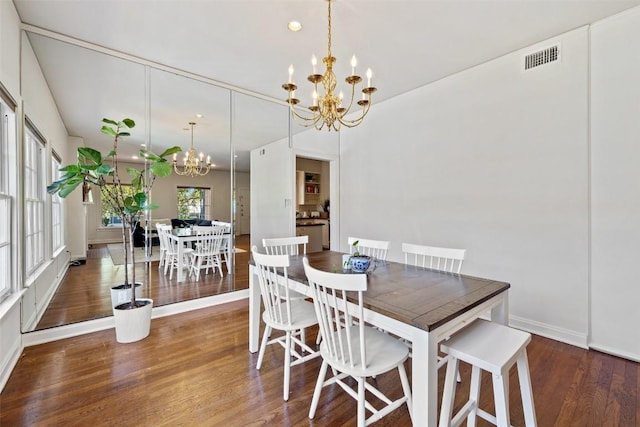 dining room featuring dark hardwood / wood-style floors and a chandelier