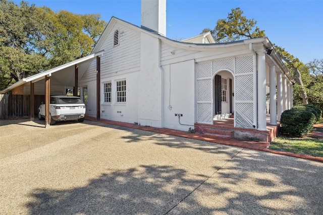 view of side of home with a carport