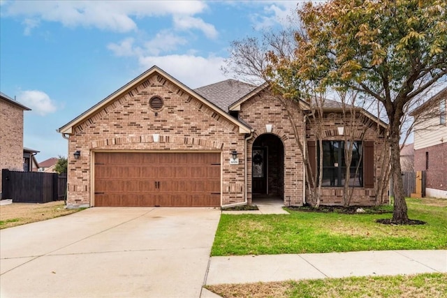 view of front of property featuring a garage and a front lawn