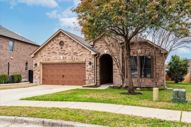 view of front facade with a garage and a front lawn