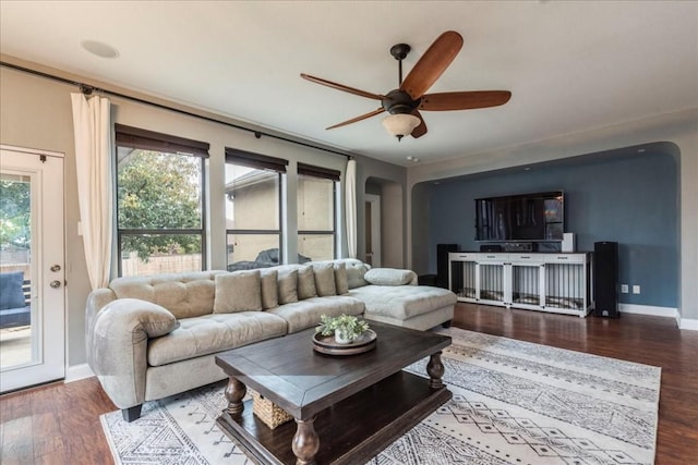 living room featuring dark hardwood / wood-style floors and ceiling fan