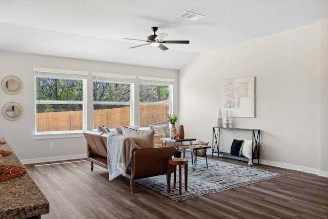 living room with ceiling fan, lofted ceiling, a healthy amount of sunlight, and dark hardwood / wood-style floors