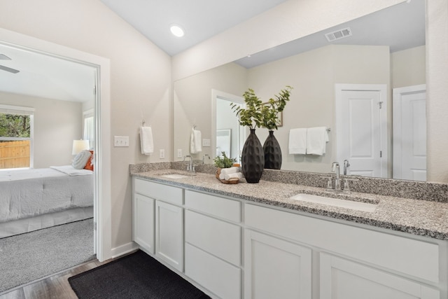 bathroom with ceiling fan, vanity, and hardwood / wood-style floors