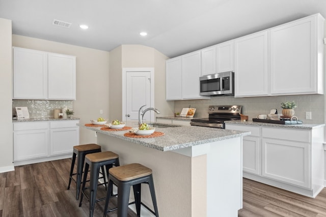 kitchen with appliances with stainless steel finishes and white cabinets