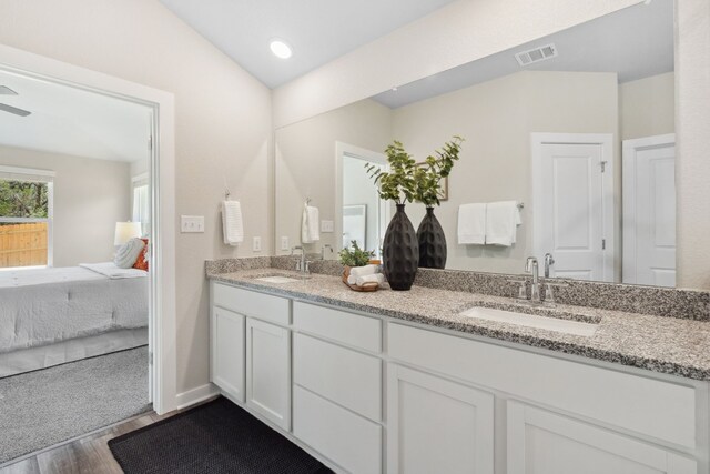 bathroom featuring hardwood / wood-style flooring, ceiling fan, and vanity