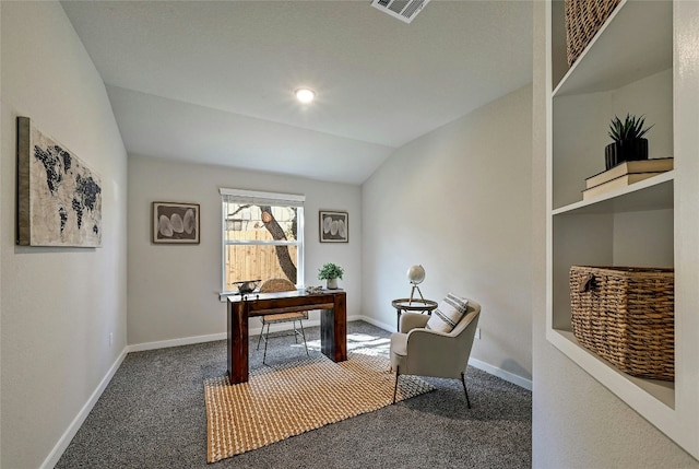 carpeted home office with vaulted ceiling