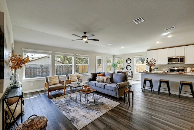 living room featuring dark hardwood / wood-style floors and ceiling fan