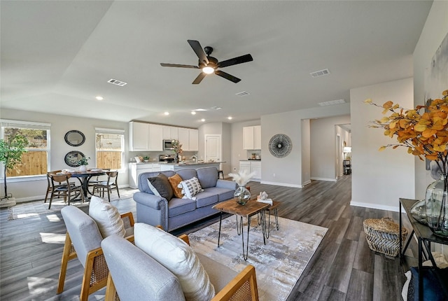 living room featuring dark hardwood / wood-style flooring and ceiling fan