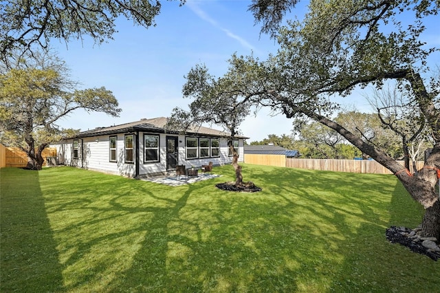 rear view of property with a yard