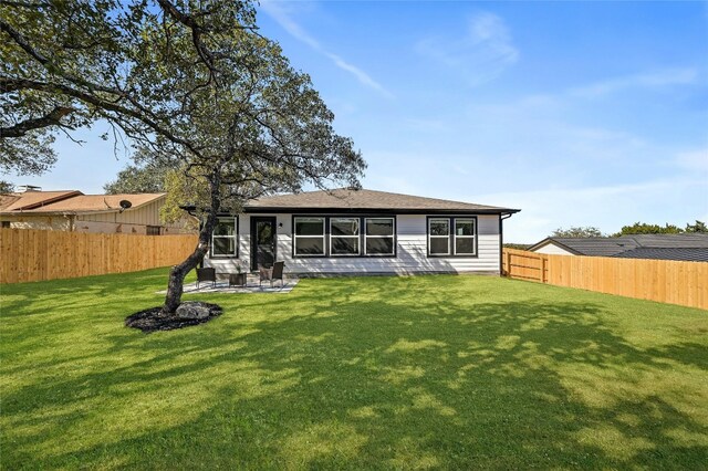 back of house featuring a yard