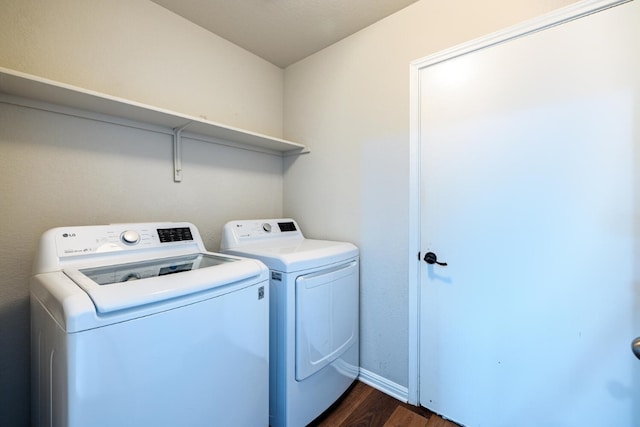 clothes washing area featuring independent washer and dryer and dark hardwood / wood-style flooring