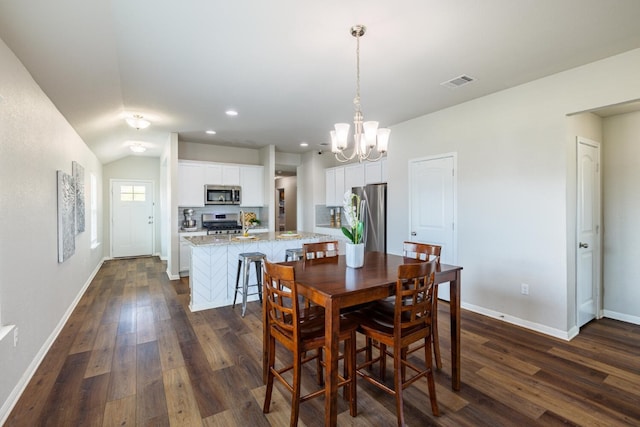 dining area with dark hardwood / wood-style floors and a chandelier