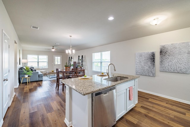 kitchen featuring decorative light fixtures, dishwasher, an island with sink, sink, and white cabinets