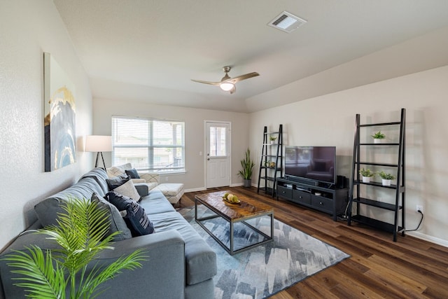 living room with dark wood-type flooring, ceiling fan, and vaulted ceiling