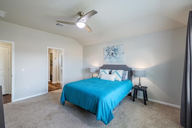 bedroom featuring vaulted ceiling, ceiling fan, carpet floors, and ensuite bath