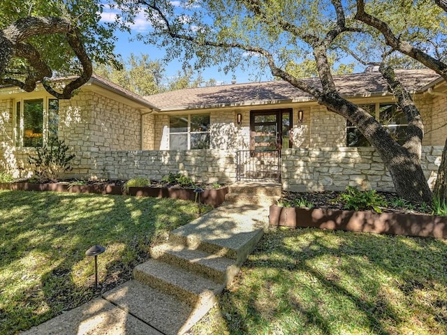 ranch-style home with a front lawn