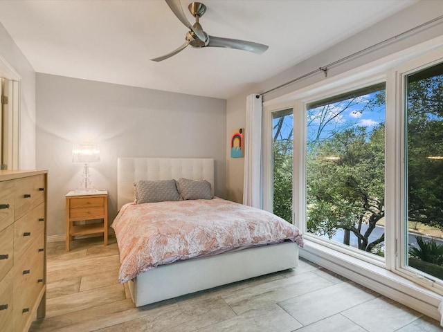 bedroom with ceiling fan and light wood-type flooring