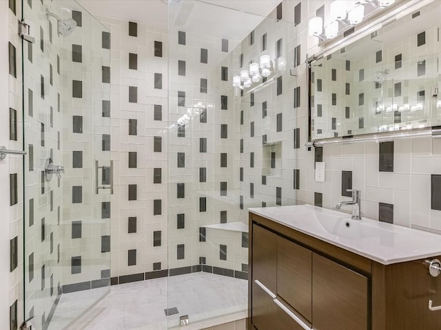 bathroom featuring vanity, a tile shower, and backsplash