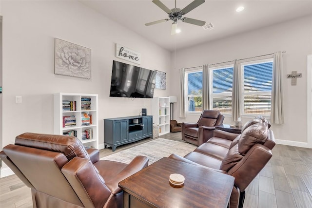 living room with ceiling fan and light hardwood / wood-style floors