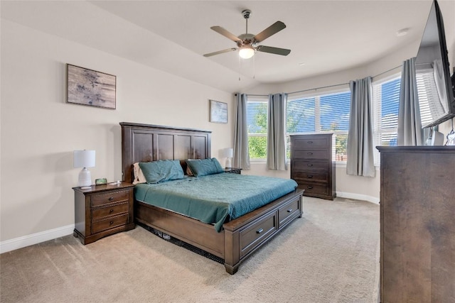 bedroom featuring ceiling fan, light colored carpet, and lofted ceiling