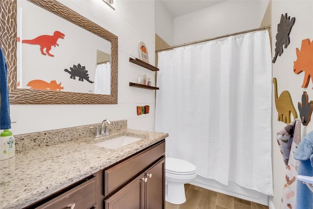 bathroom featuring wood-type flooring, vanity, and toilet