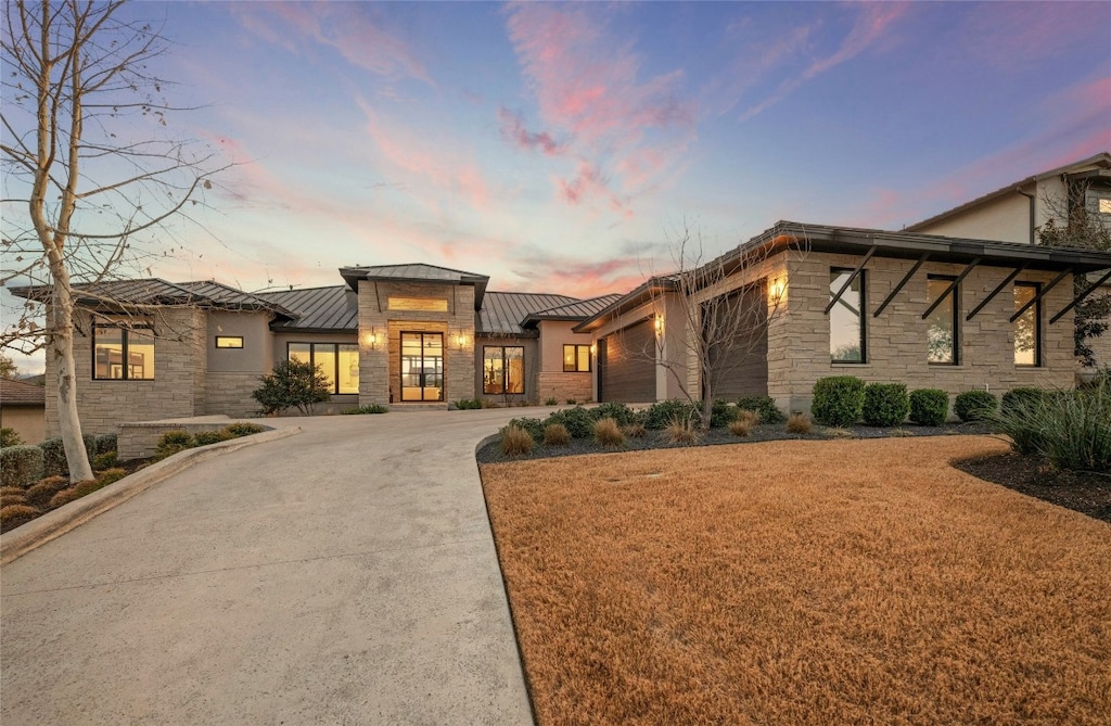 view of front of home with a yard and a garage